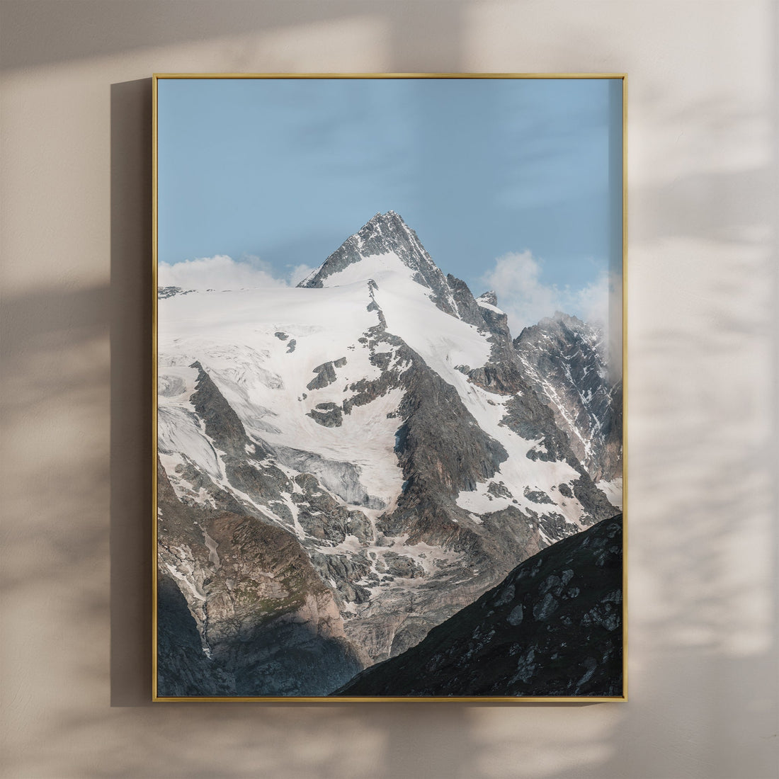 Fine art print of Grossglockner peak with golden frame and soft wall shadows.