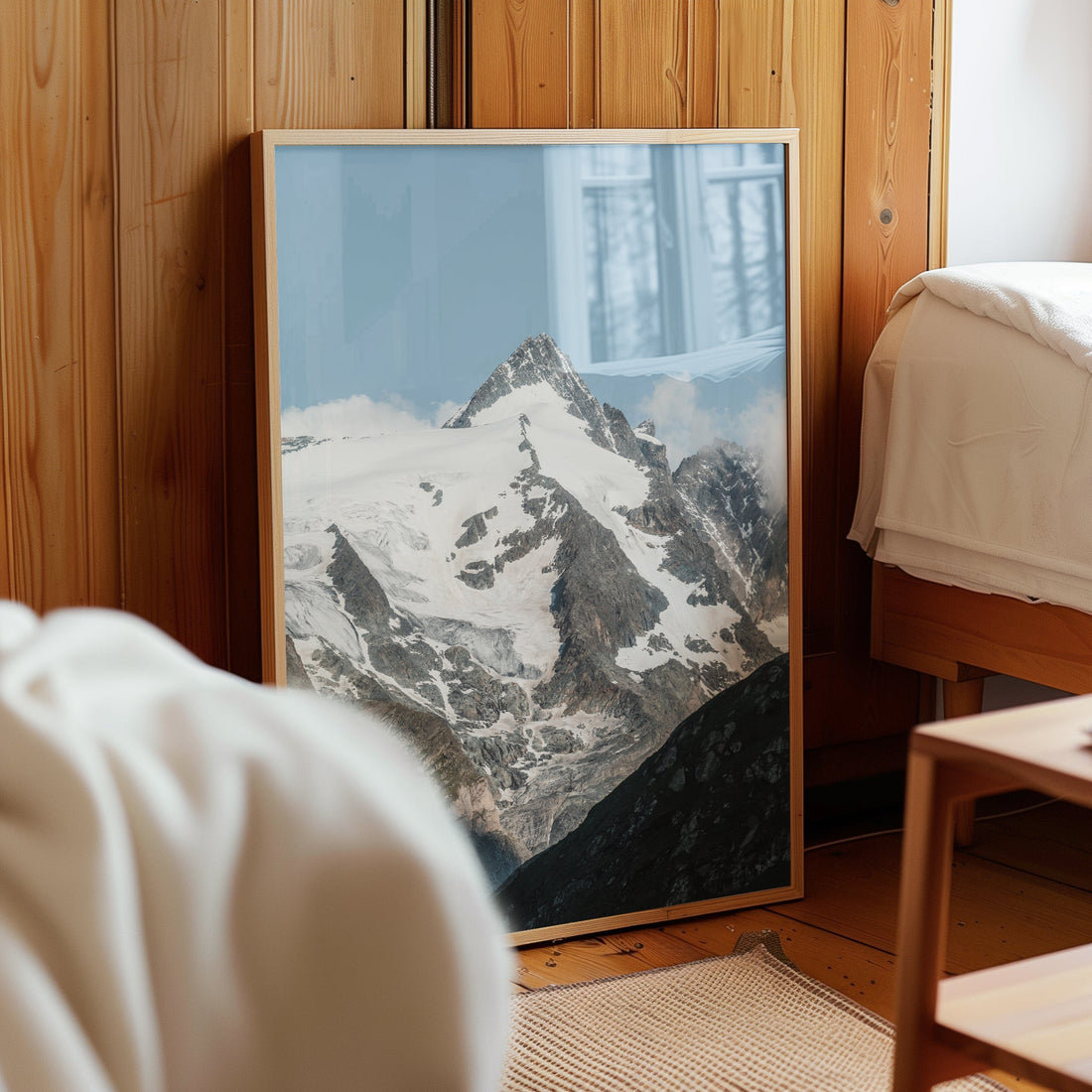 Grossglockner mountain poster styled in cosy alpine bedroom next to bed.