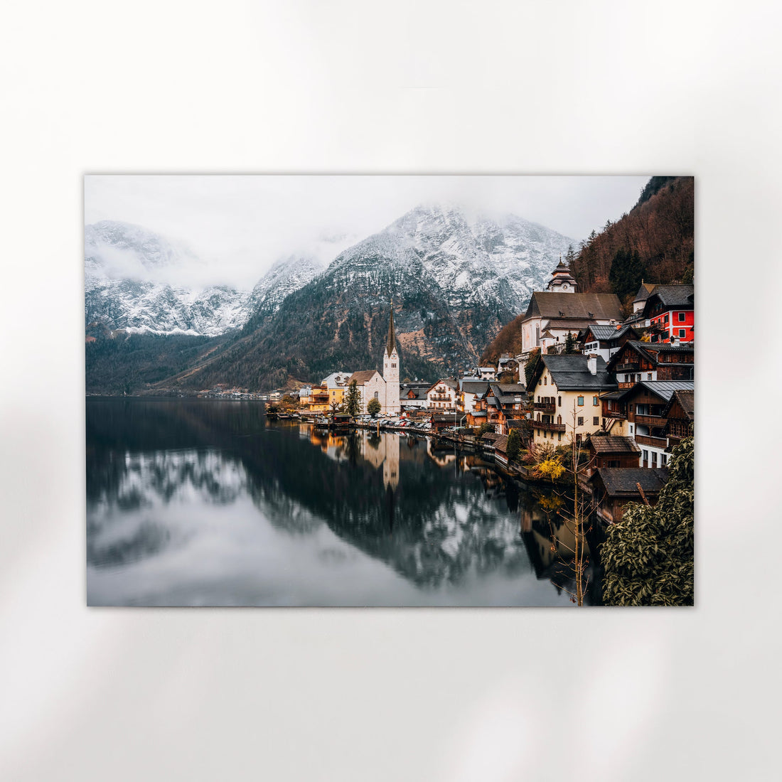 Minimalist print of Hallstatt by the water, featuring snowy peaks and traditional alpine houses.