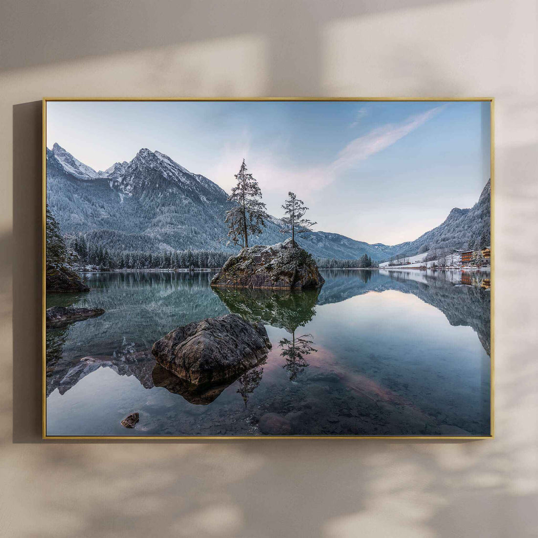 Golden sunrise over Hintersee lake with glowing mountains and reflections
