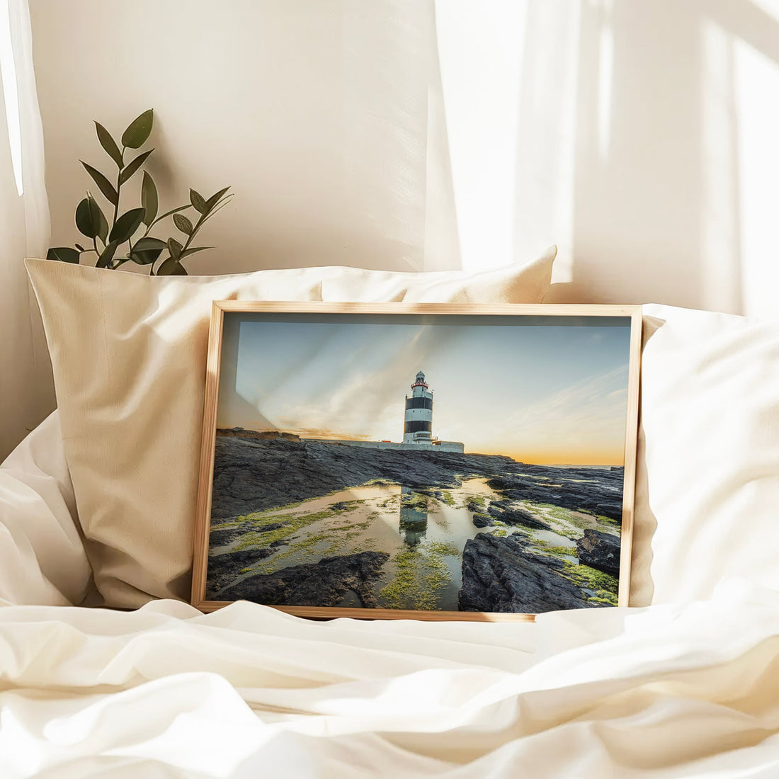 Coastal wall art showing Hook Head Lighthouse on rocky cliffs.