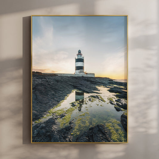 Hook Head Lighthouse at sunset with soft blue sky and golden light, coastal Irish wall art print