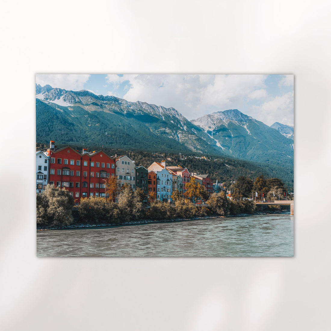 Minimal studio view of Innsbruck print with Tyrolean mountain scene and colourful buildings.