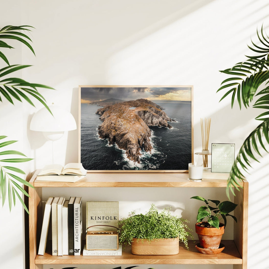 Sheep’s Head Peninsula print styled in a bright interior with plants and books.