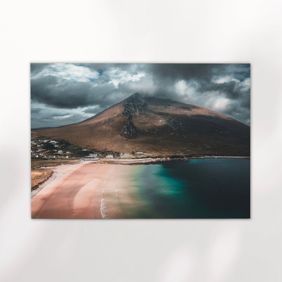 Fine art print of Dugort Beach coastline showing pink sand, emerald waters, and a rugged mountain.