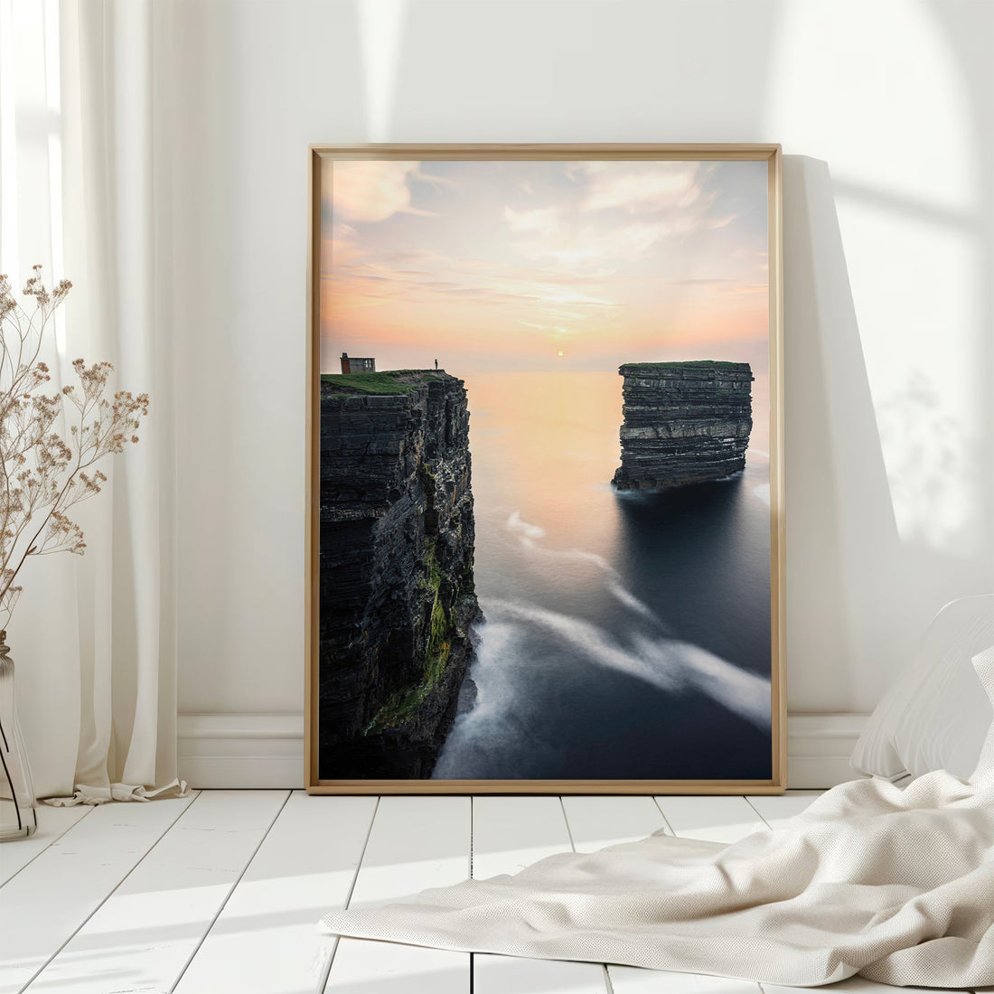 Framed Irish coastal print of Downpatrick Head cliffs with misty sea on white floor.
