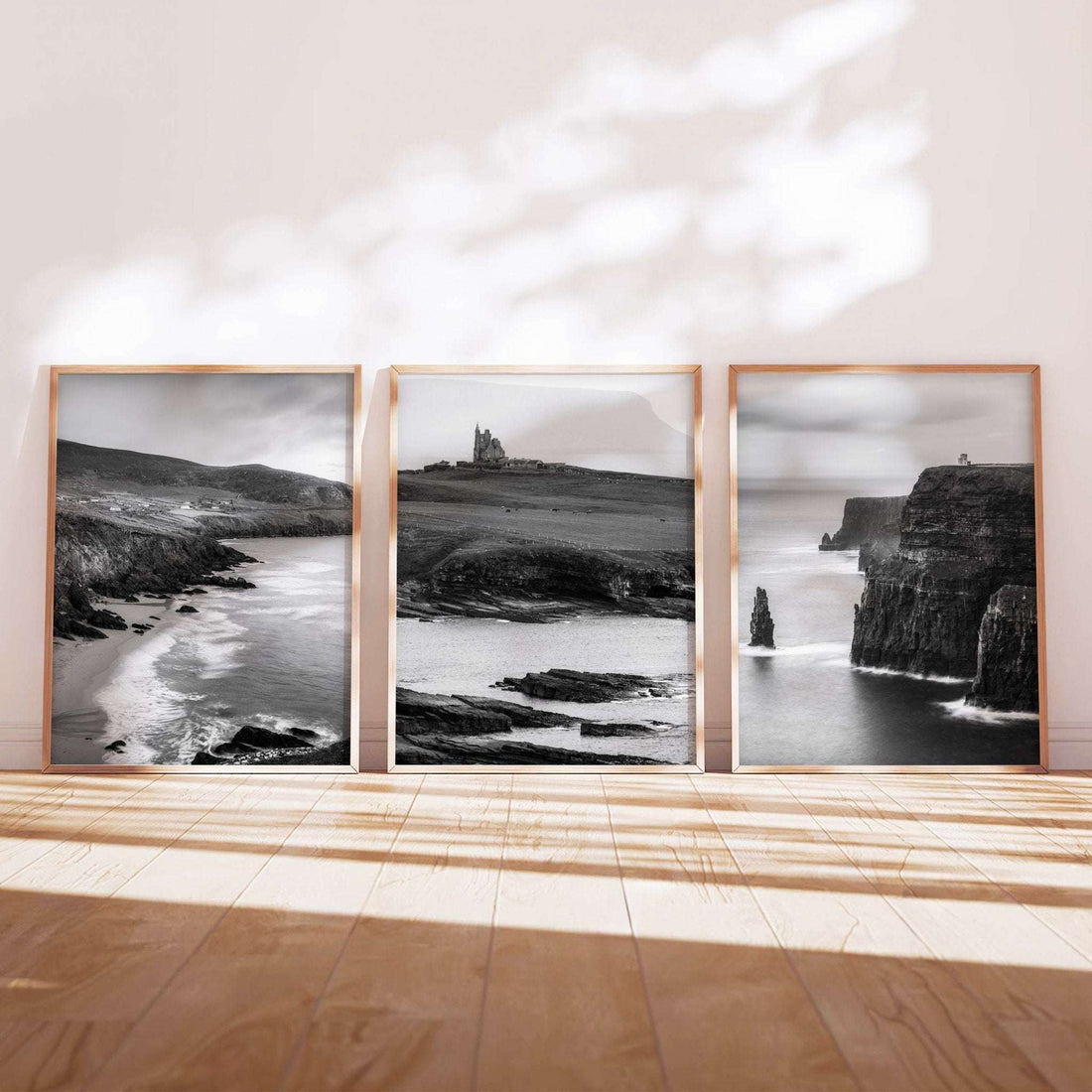 Black and white Ireland wall art set of three featuring Dunquin Harbour, Gougane Barra, and Doonagore Castle displayed as framed prints