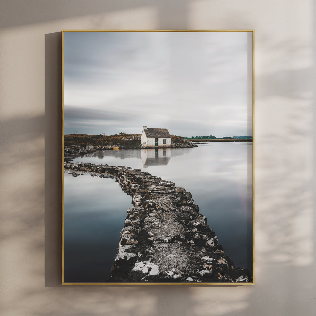 Fine art print of an Irish bothy reflecting in calm water, wall-mounted
