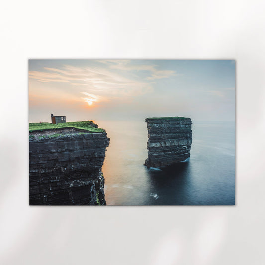Print of Downpatrick Head sea stack on white wall with long exposure ocean and warm sky