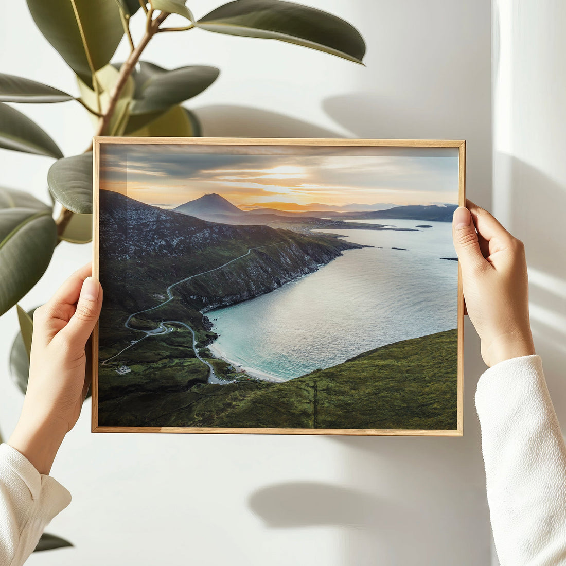 Framed Keem Beach print being held in hands with natural indoor lighting