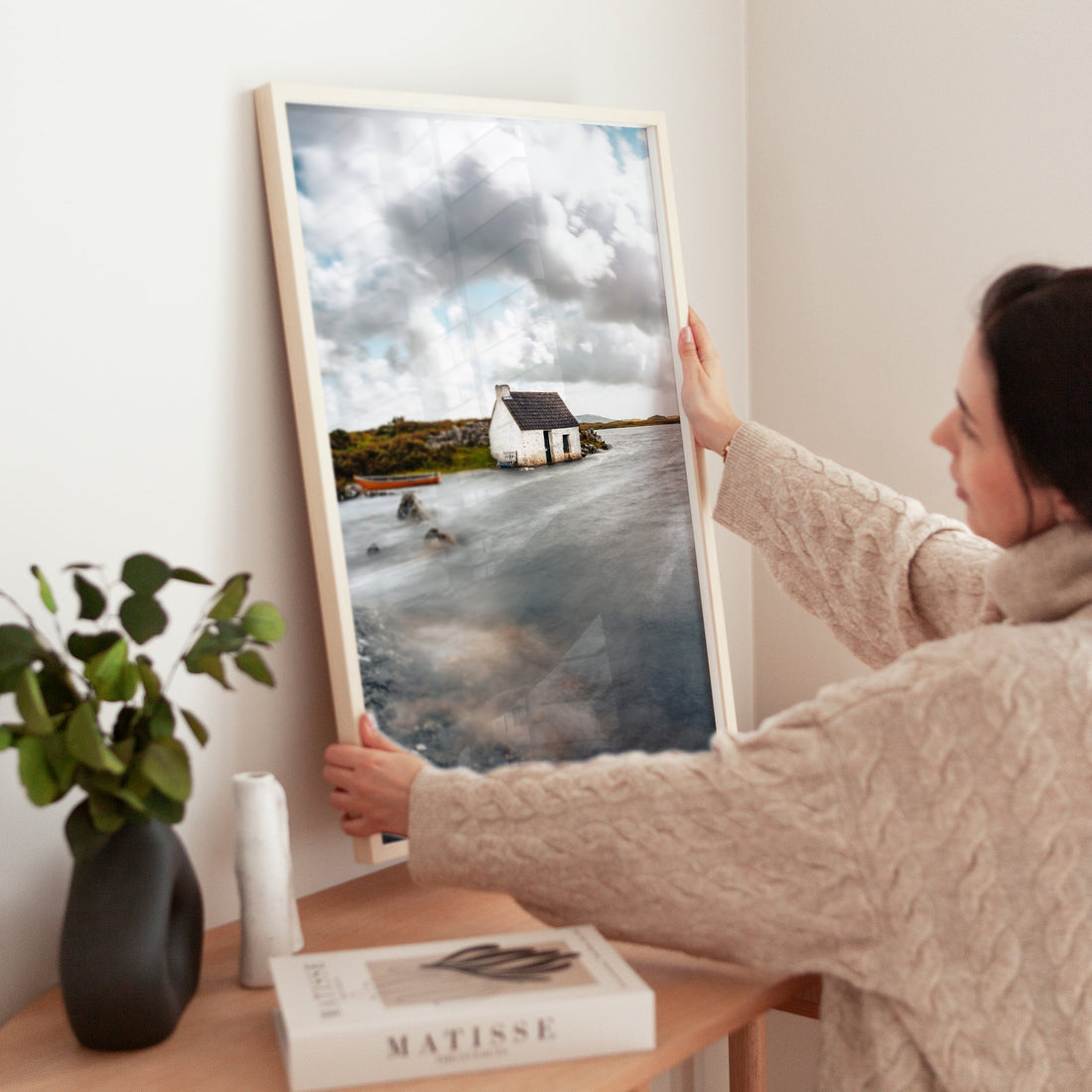 Framed fisherman's bothy print held in modern home interior