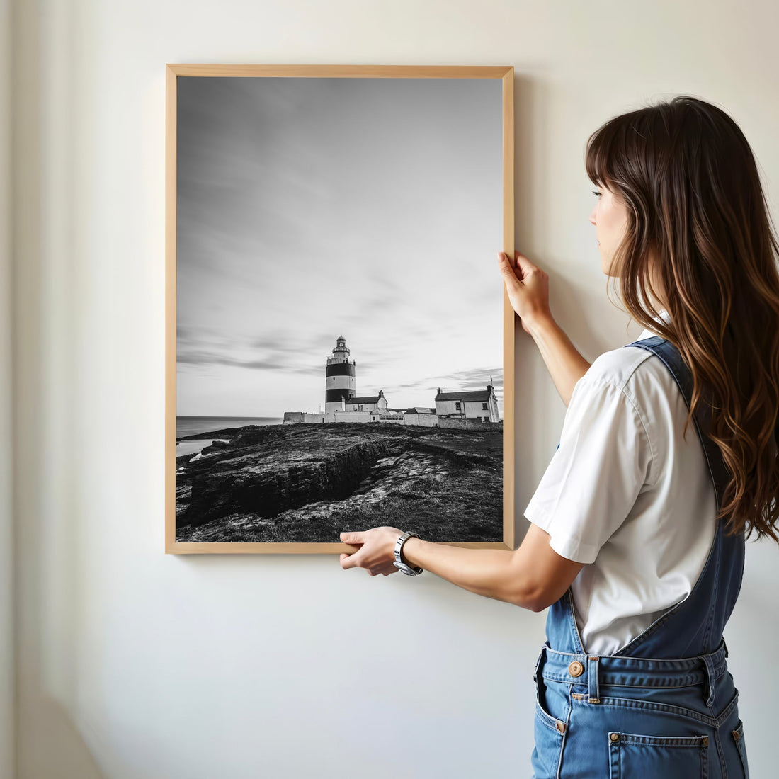 Woman hanging Hook Head Lighthouse photo print on wall