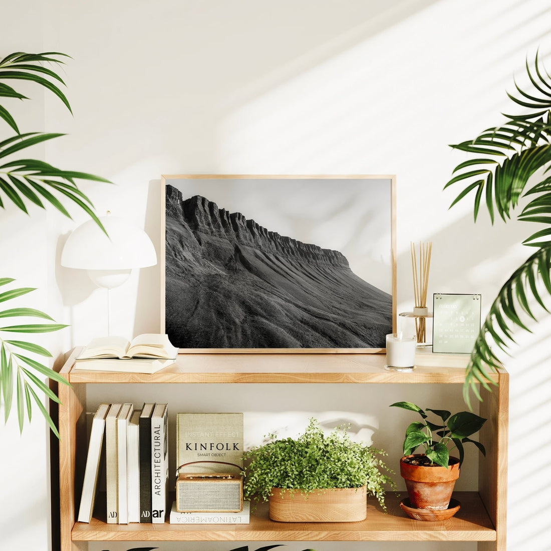 Benbulbin wall art styled in bright home decor with plants and books