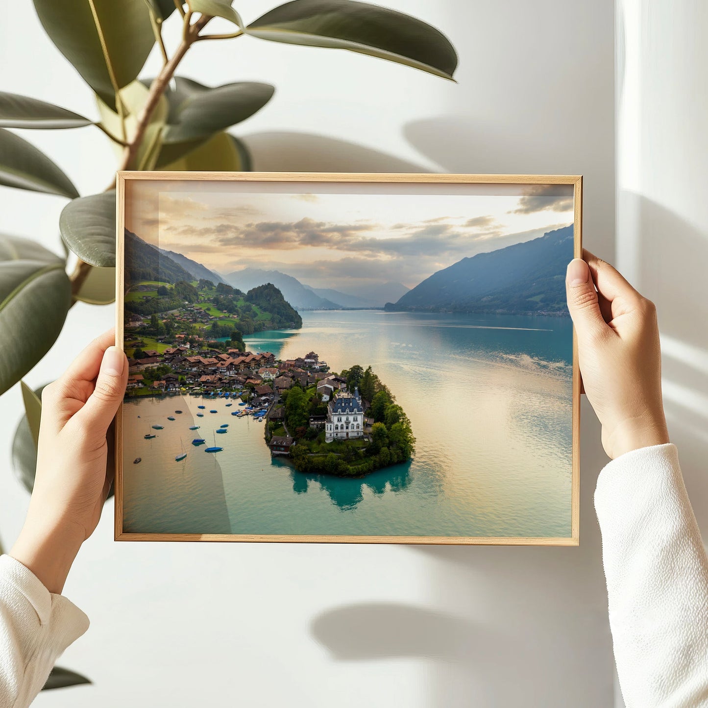 Drone shot of the iconic Iseltwald Castle on Lake Brienz, Switzerland, surrounded by serene waters and alpine peaks.