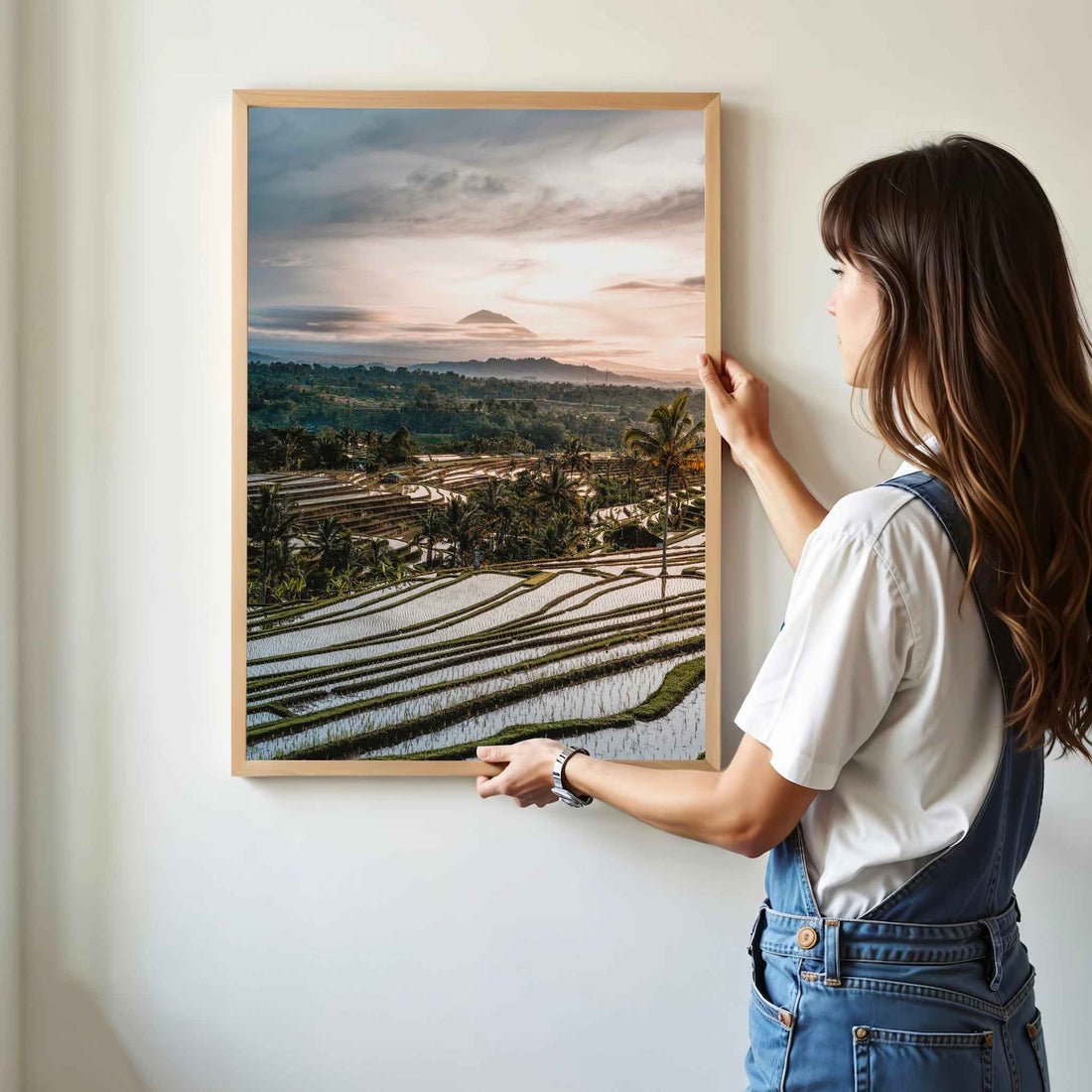 Woman hanging Jatiluwih rice terraces Bali framed wall art print with Mount Agung in natural oak wood frame on white wall