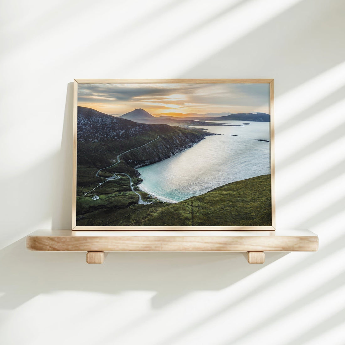 Aerial coastal print of Keem Beach on a sunlit white shelf in minimalist interior
