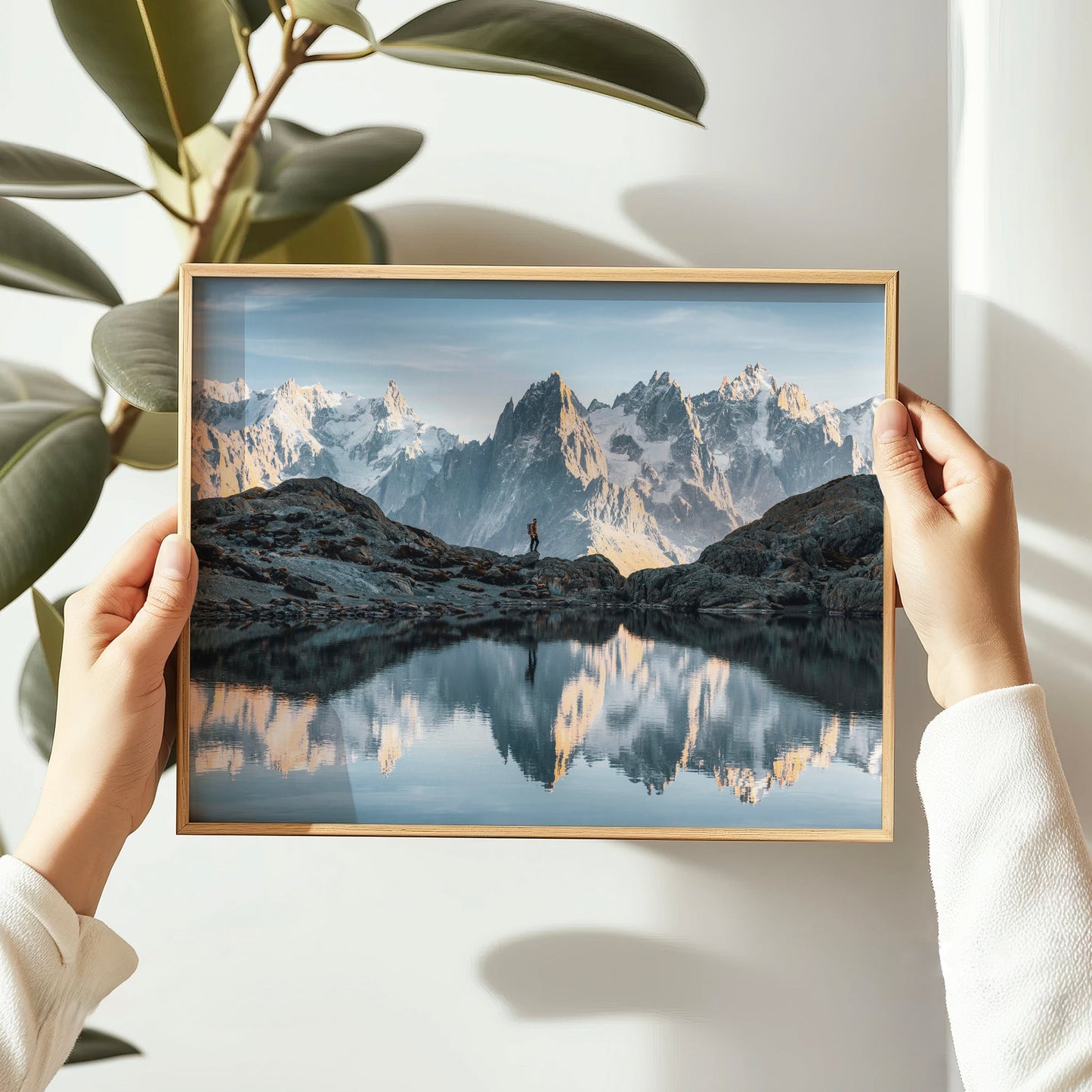 Lac Blanc landscape photography featuring a solo hiker and panoramic Mont Blanc mountain range.