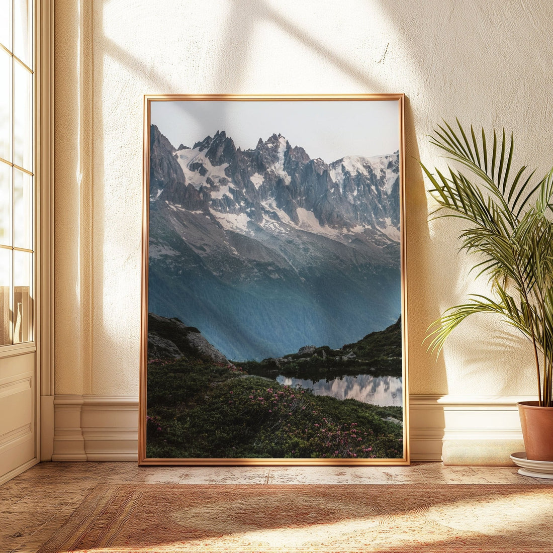 Foreground of alpine flowers framing the tranquil Lac de la Flégère and surrounding peaks.