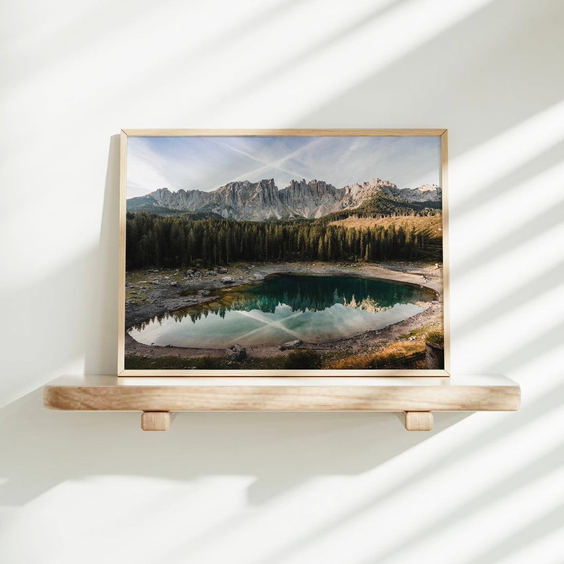 Sunlit Lago di Carezza art print on shelf with dramatic natural shadows