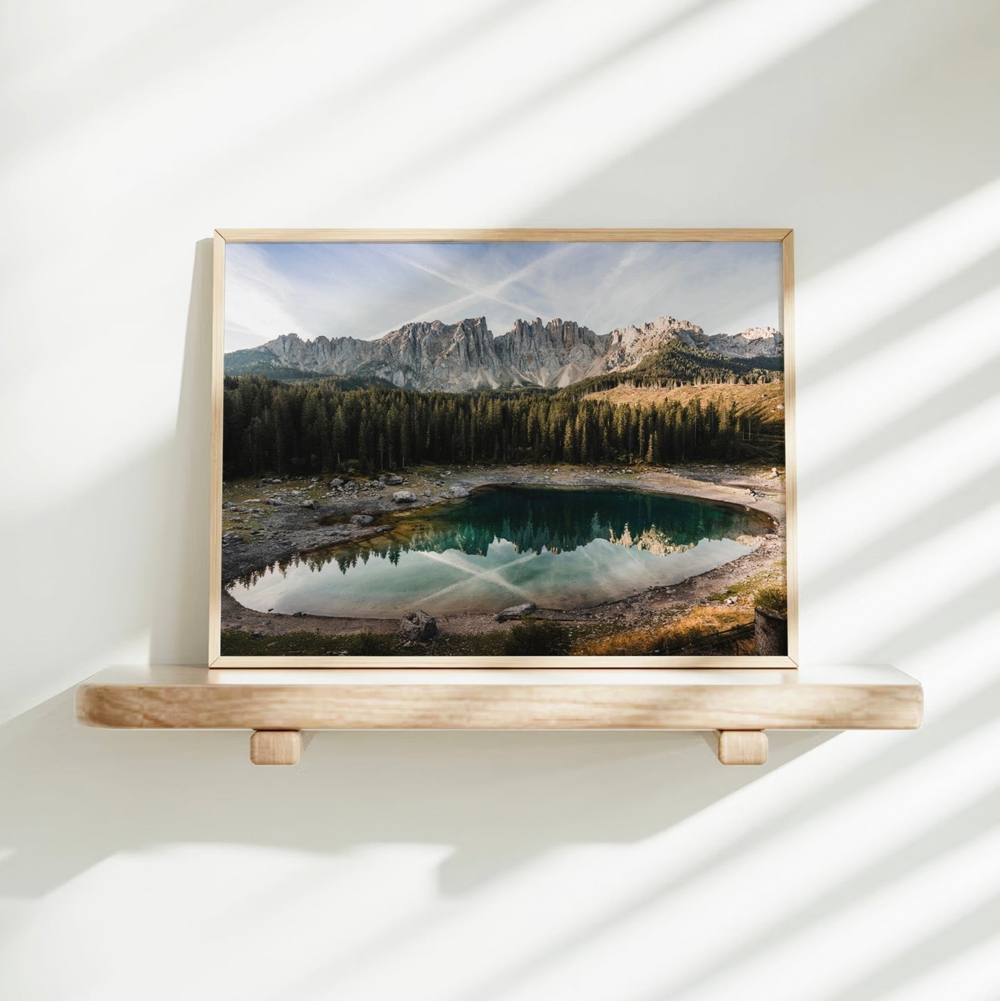 Sunlit Lago di Carezza art print on shelf with dramatic natural shadows