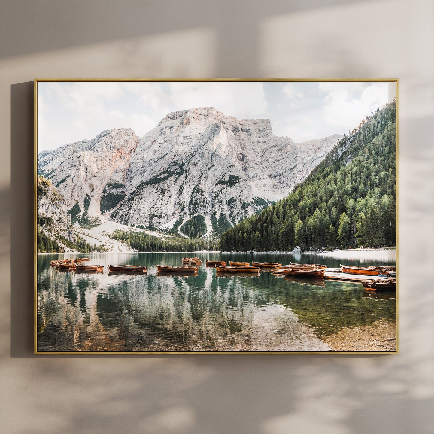 Lago di Braies wall art print with wooden boats reflecting in turquoise alpine lake, set against dramatic Dolomites peaks.