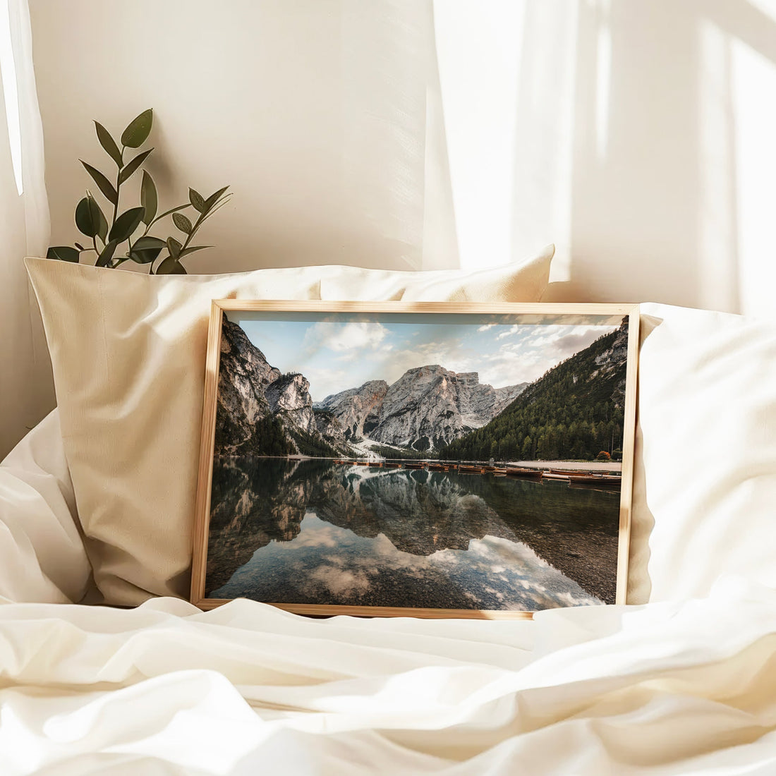 Peaceful Lago di Braies lake reflection print resting on neutral bedding