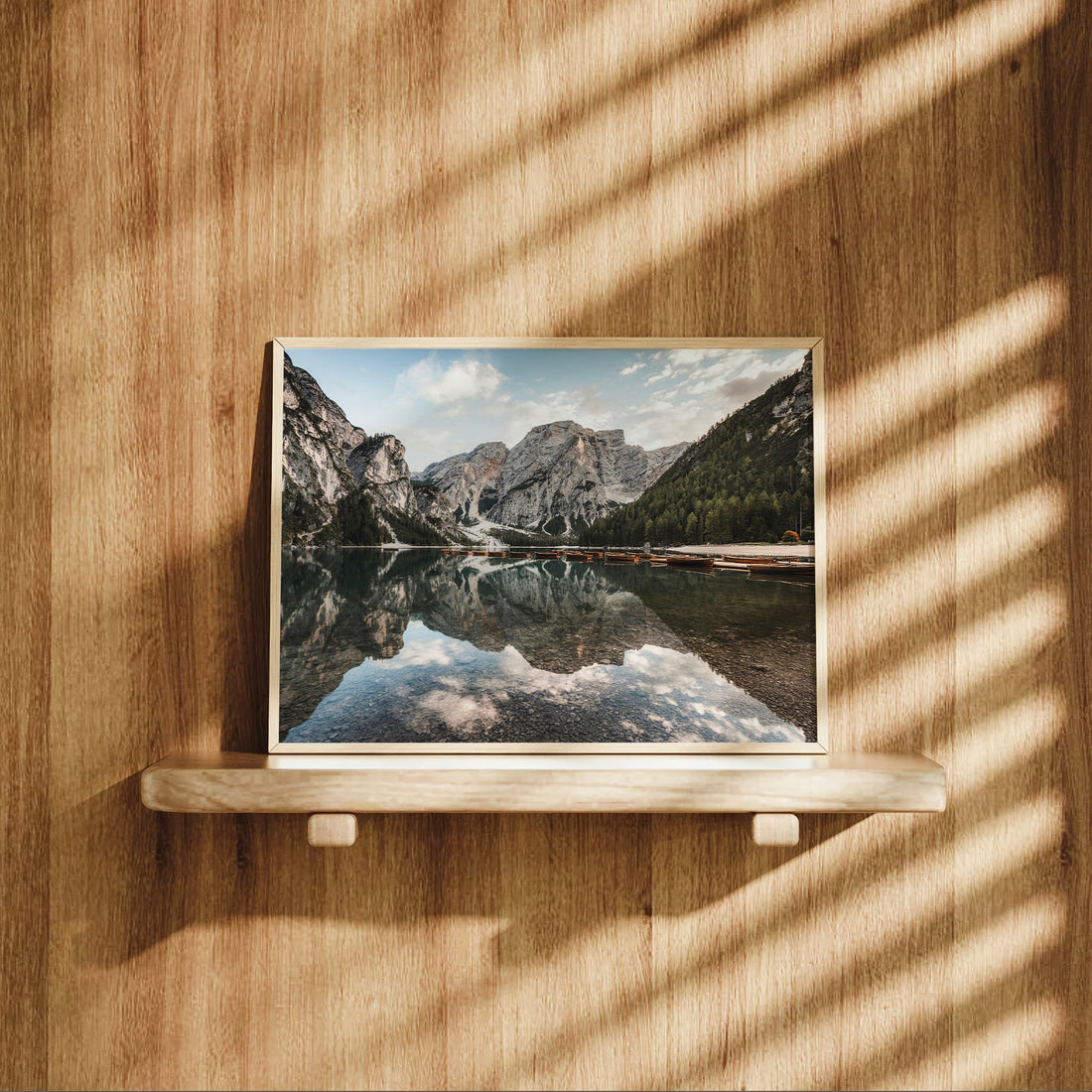 Lago di Braies photography print styled on shelf with warm wooden background