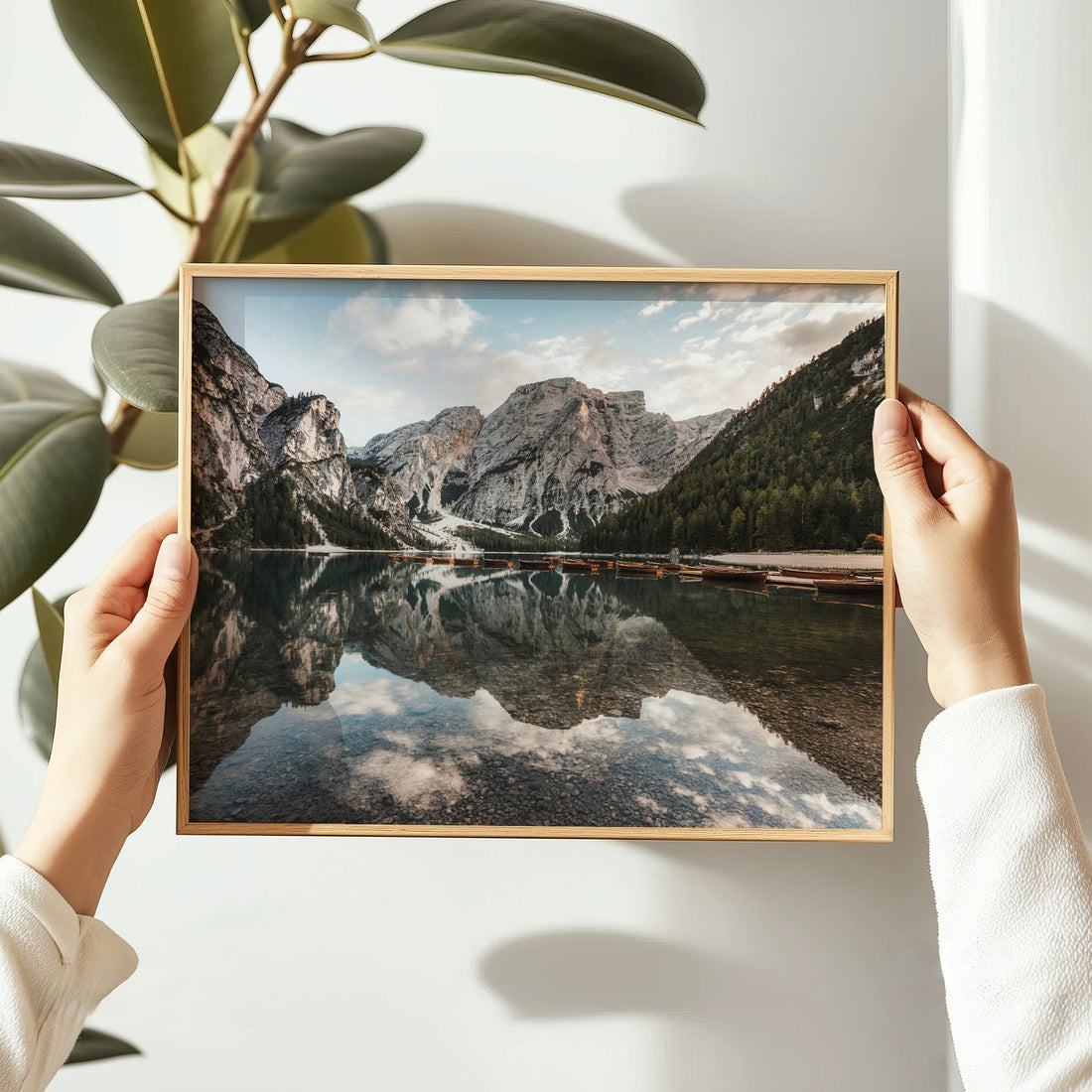 Hands holding Lago di Braies reflection photography print, Dolomites Italy
