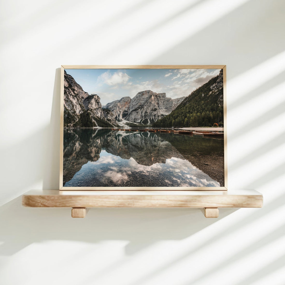 Lago di Braies photography wall art displayed on shelf with soft light