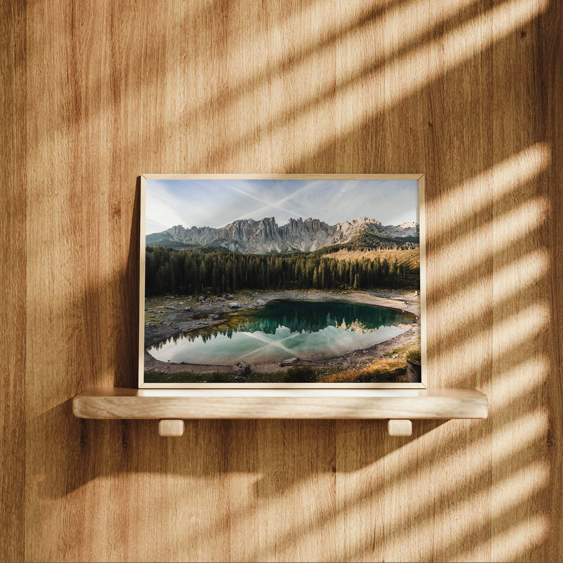 Lago di Carezza print on shelf with light wood background and shadows
