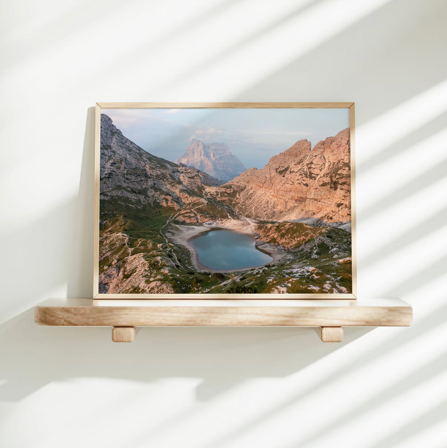 Mountain lake photography print on shelf with soft shadows