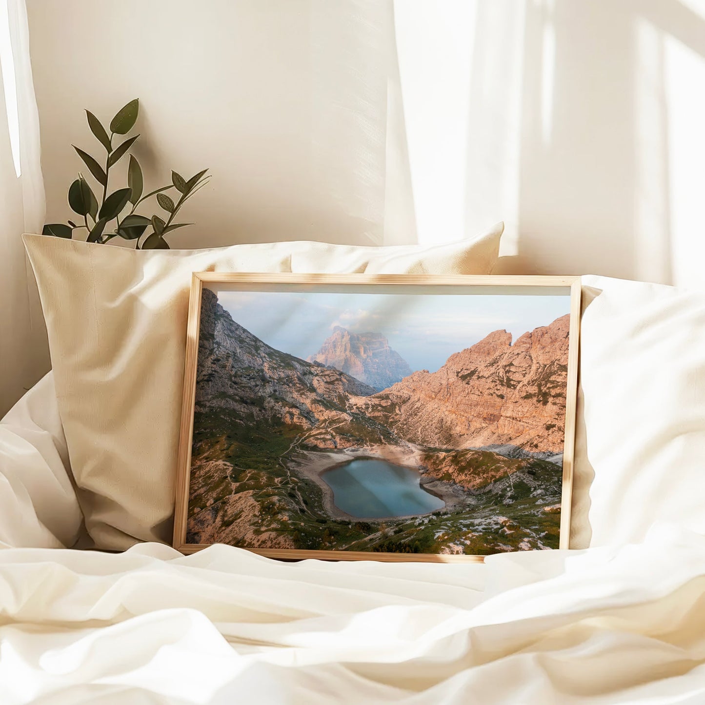 Serene lake and mountain landscape print styled on a bed