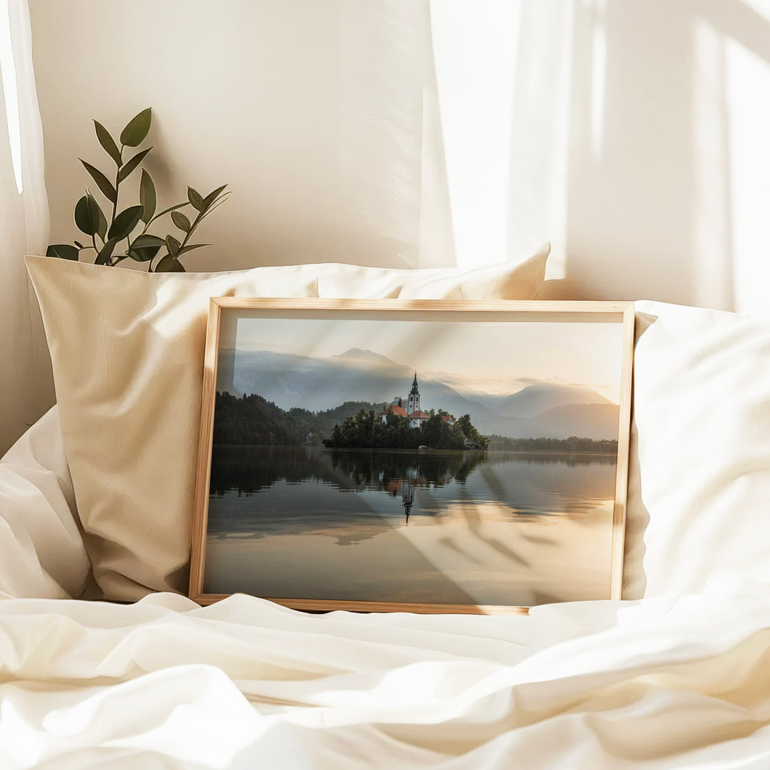Framed photo of Lake Bled with mountain layers in background
