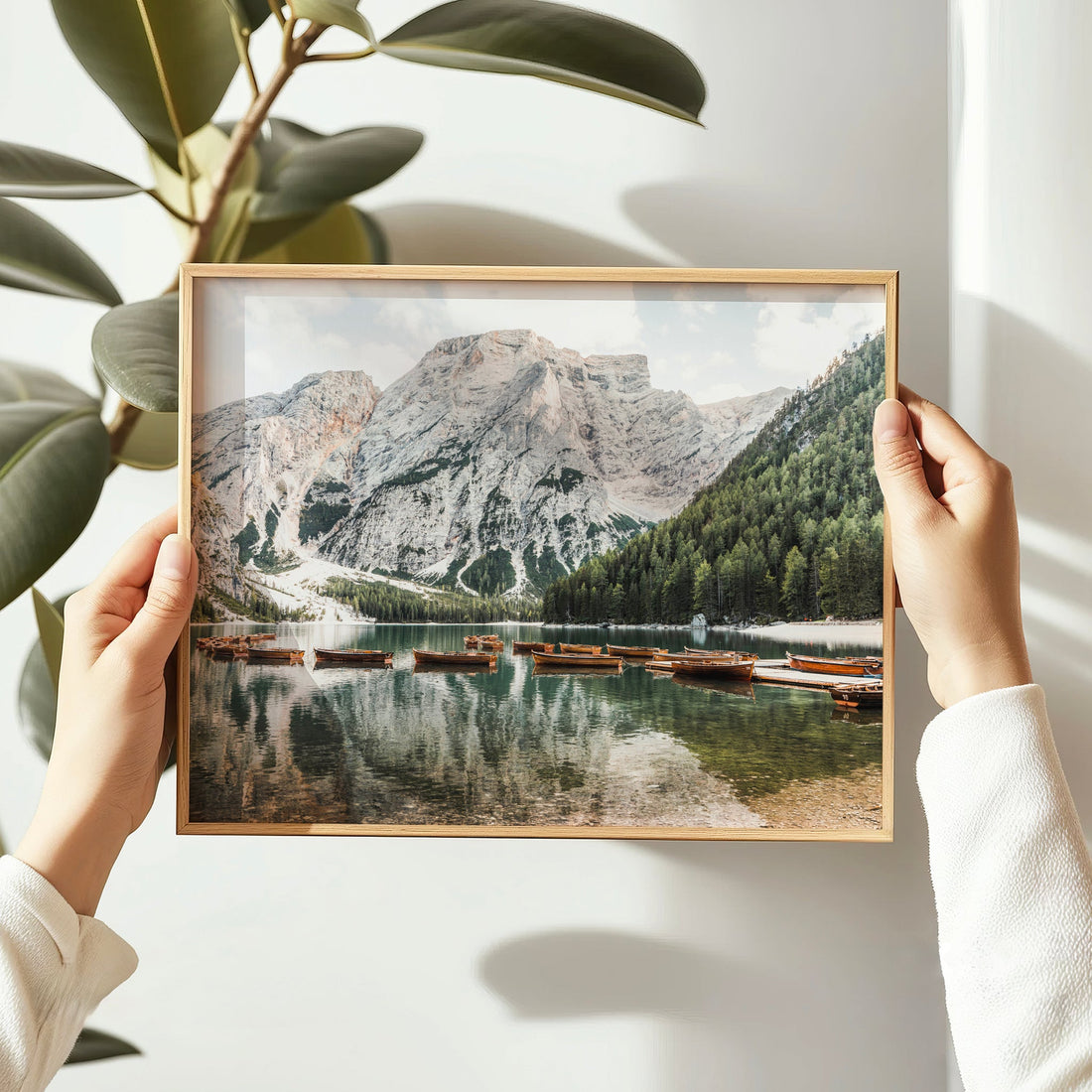 Lake Braies photography print capturing calm reflections of the Alps and boats at golden hour, perfect for nature-inspired interiors.