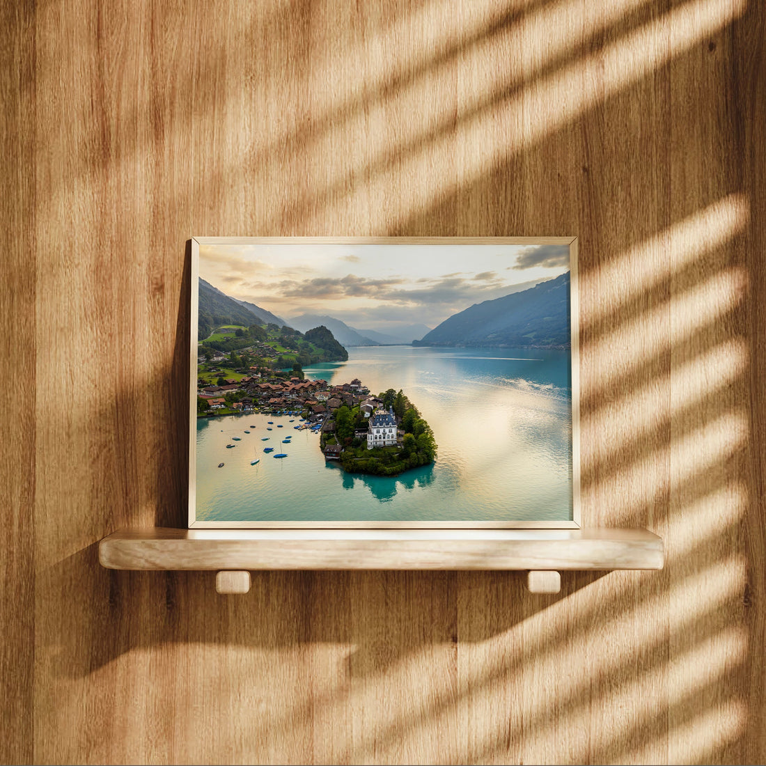 Panoramic view of Iseltwald village and Lake Brienz in Switzerland, featuring crystal-clear waters and lush green landscapes.