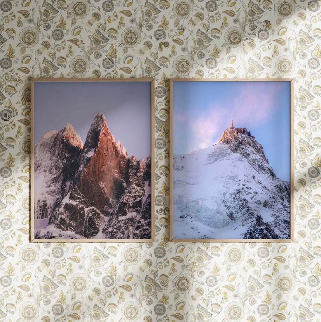 Les Drus and Aiguille du Midi mountain prints displayed on a decorative floral wall.