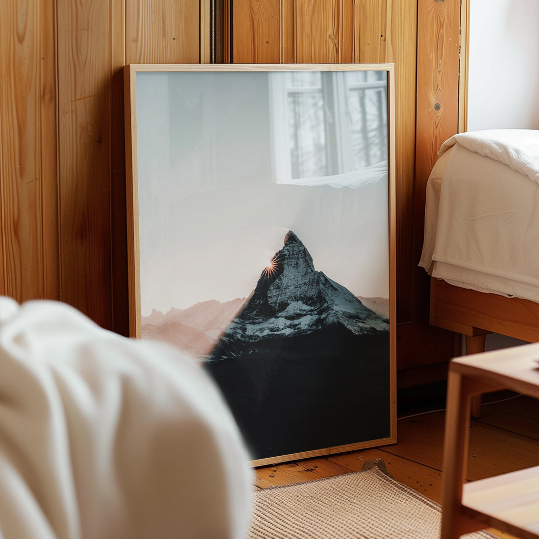 Matterhorn sunset wall art resting in a wooden bedroom filled with light