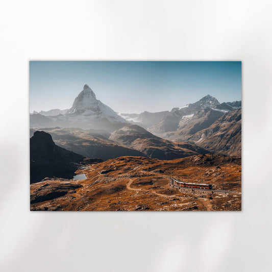 Scenic photo of the Matterhorn with the iconic Gornergrat Railway in the Swiss Alps.