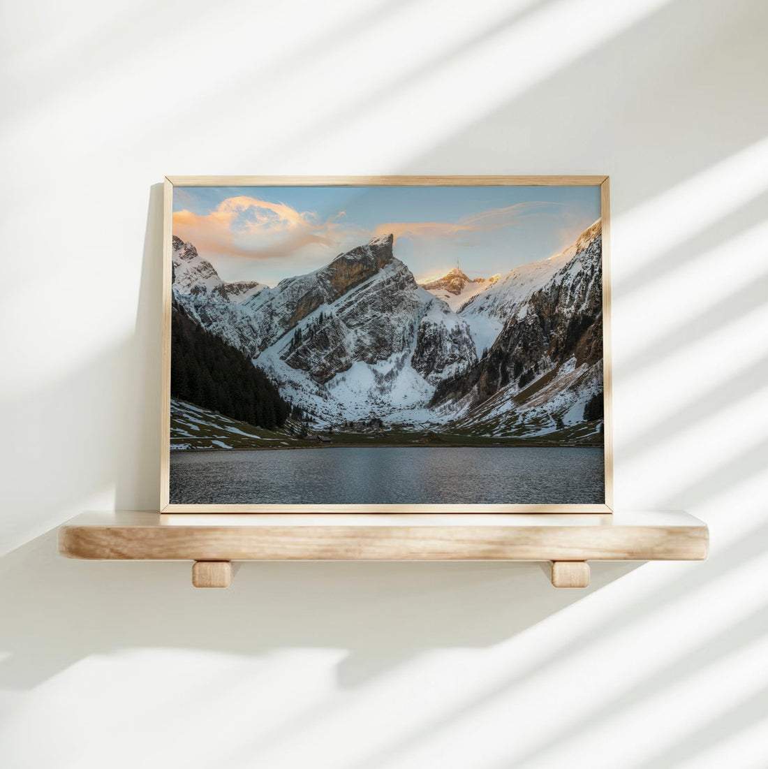 Minimalist landscape art print of a calm winter lake below towering, snow-draped alpine cliffs.