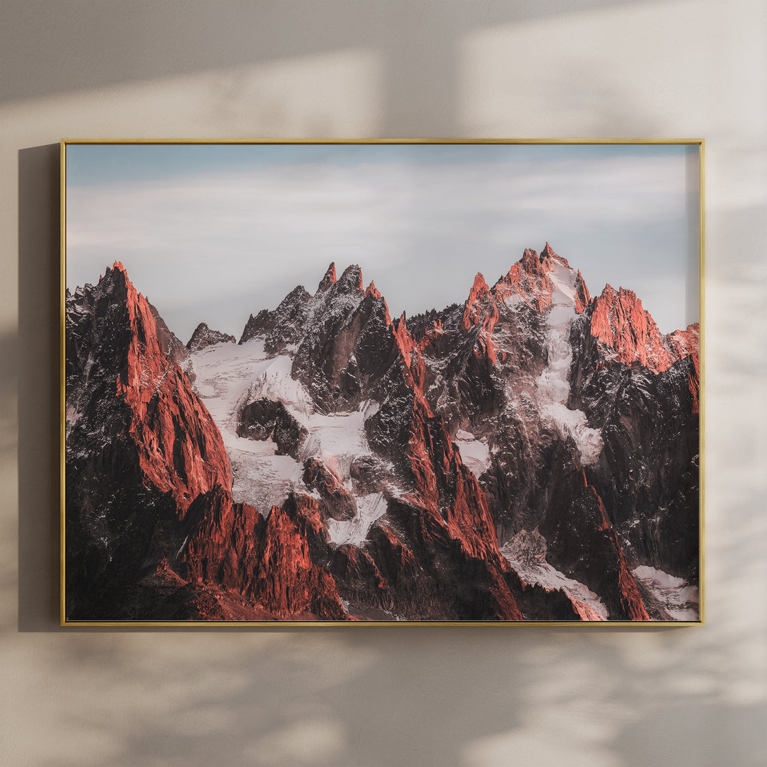 Framed Mont Blanc print showcasing the jagged Aiguilles peaks glowing in warm alpine light.