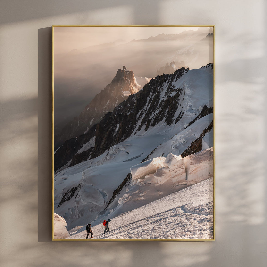 Two alpinists climbing Mont Blanc at sunrise, with dramatic snowy ridges and stunning alpine views.