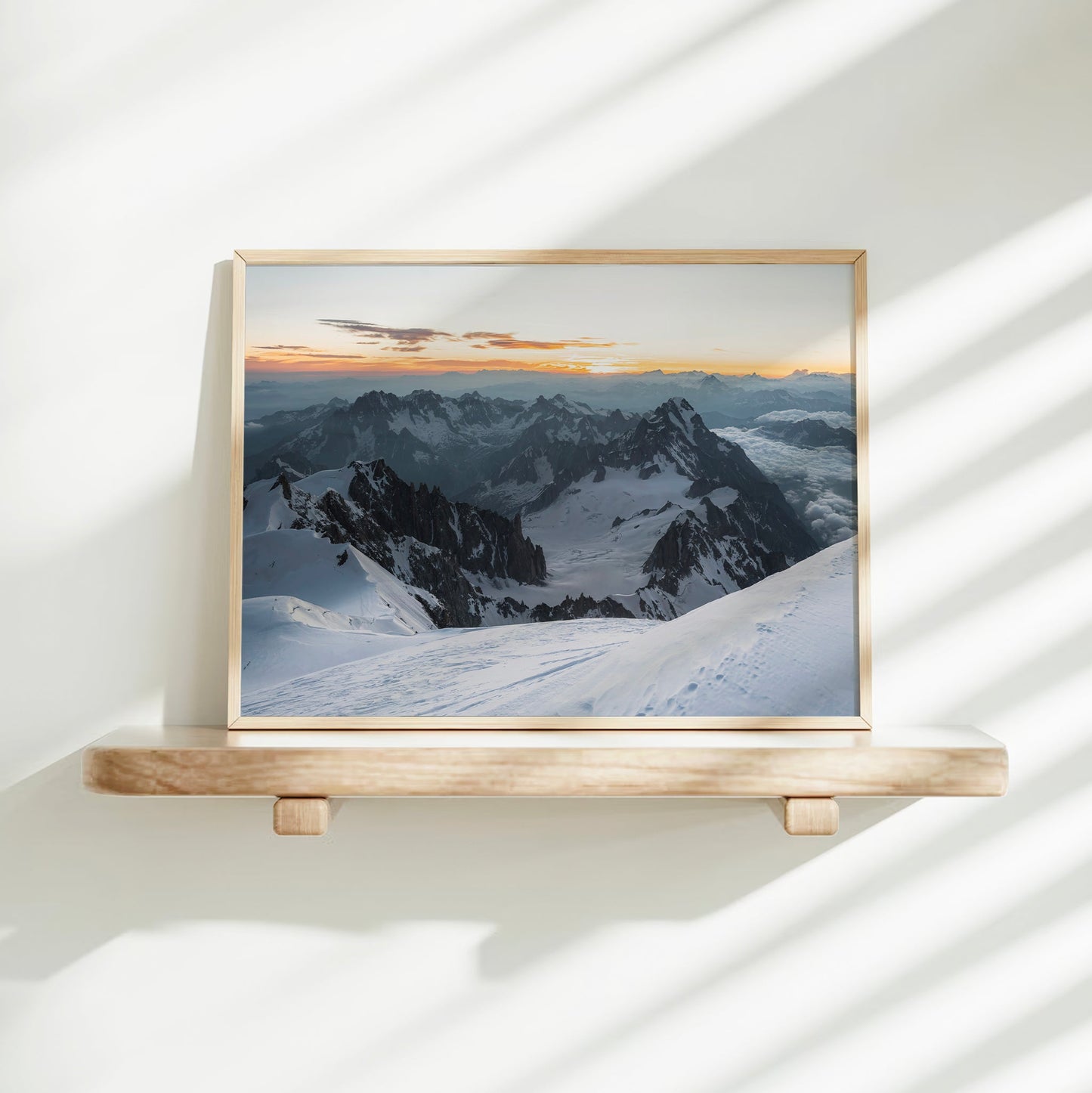 Serene landscape photo of Mont Blanc summit at dawn with snowfields and distant mountain silhouettes.