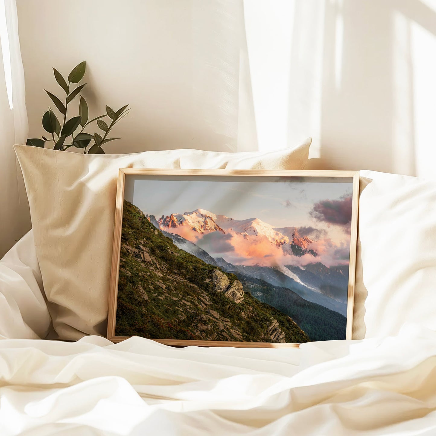 Landscape photography of Mont Blanc Massif glowing with pink hues and layered mountain slopes.