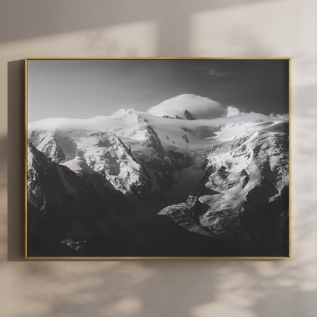 Stunning black-and-white Mont Blanc Massif wall art showcasing snow-covered peaks and dramatic light.