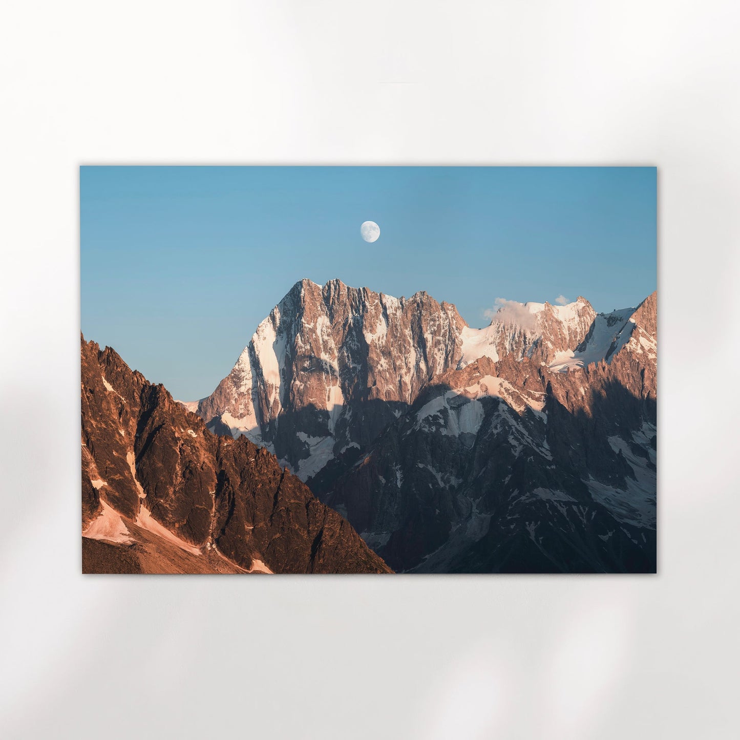 Fine art print of Grandes Jorasses at moonrise with dramatic alpine shadows and golden hour light in Chamonix.