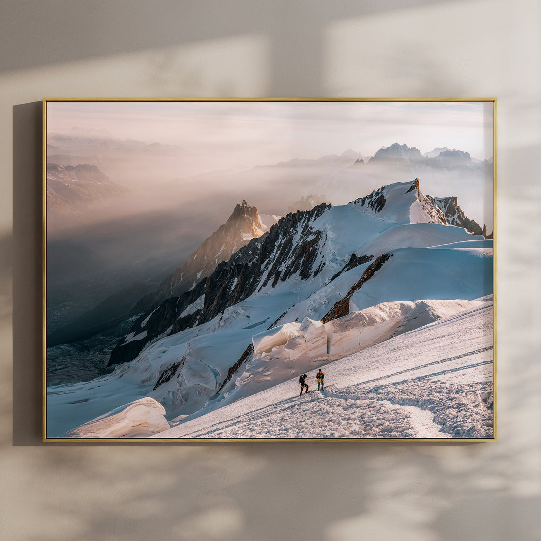 Fine art print of two alpinists ascending Mont Blanc at sunrise with misty alpine ridges in the background.