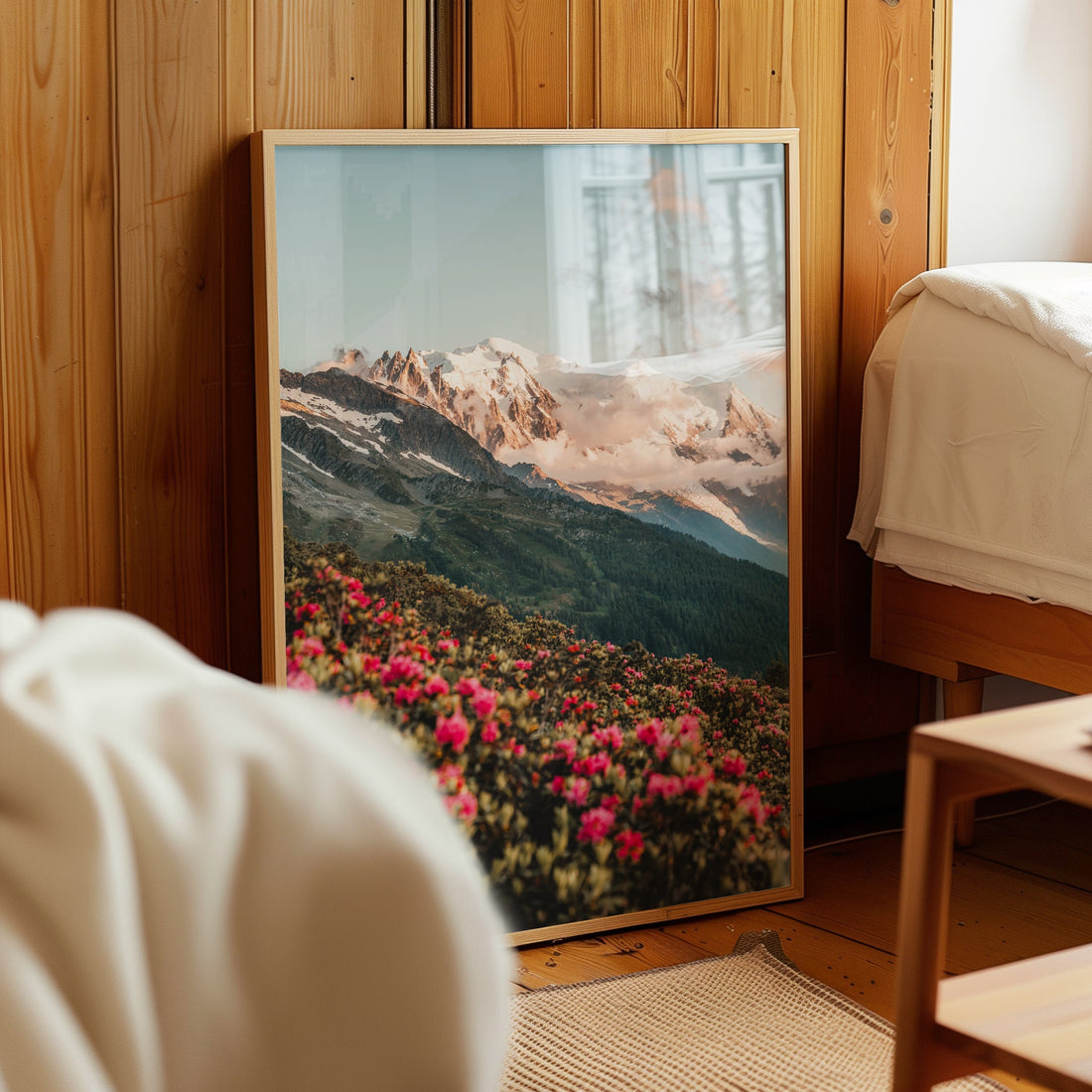 Panoramic view of Mont Blanc framed by lush alpine meadows and soft evening light.