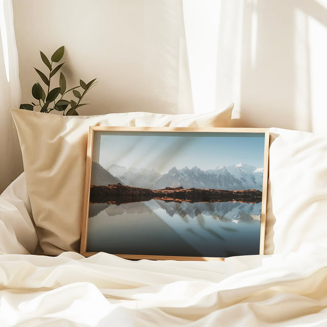 Serene mountain scene of Mont Blanc with clear lake reflections, captured above Chamonix in a peaceful alpine setting.