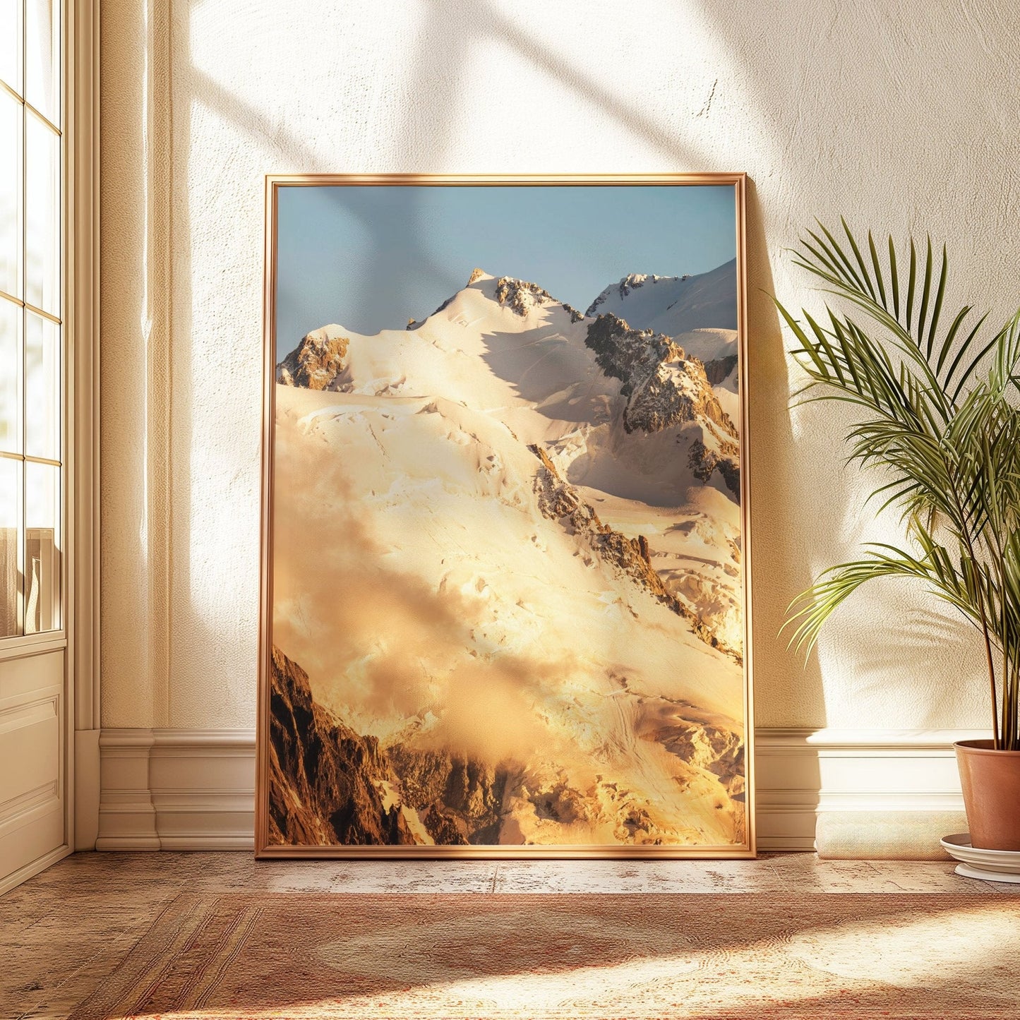 Golden sunrise illuminating the Mont Blanc massif, framed against a clear blue sky.
