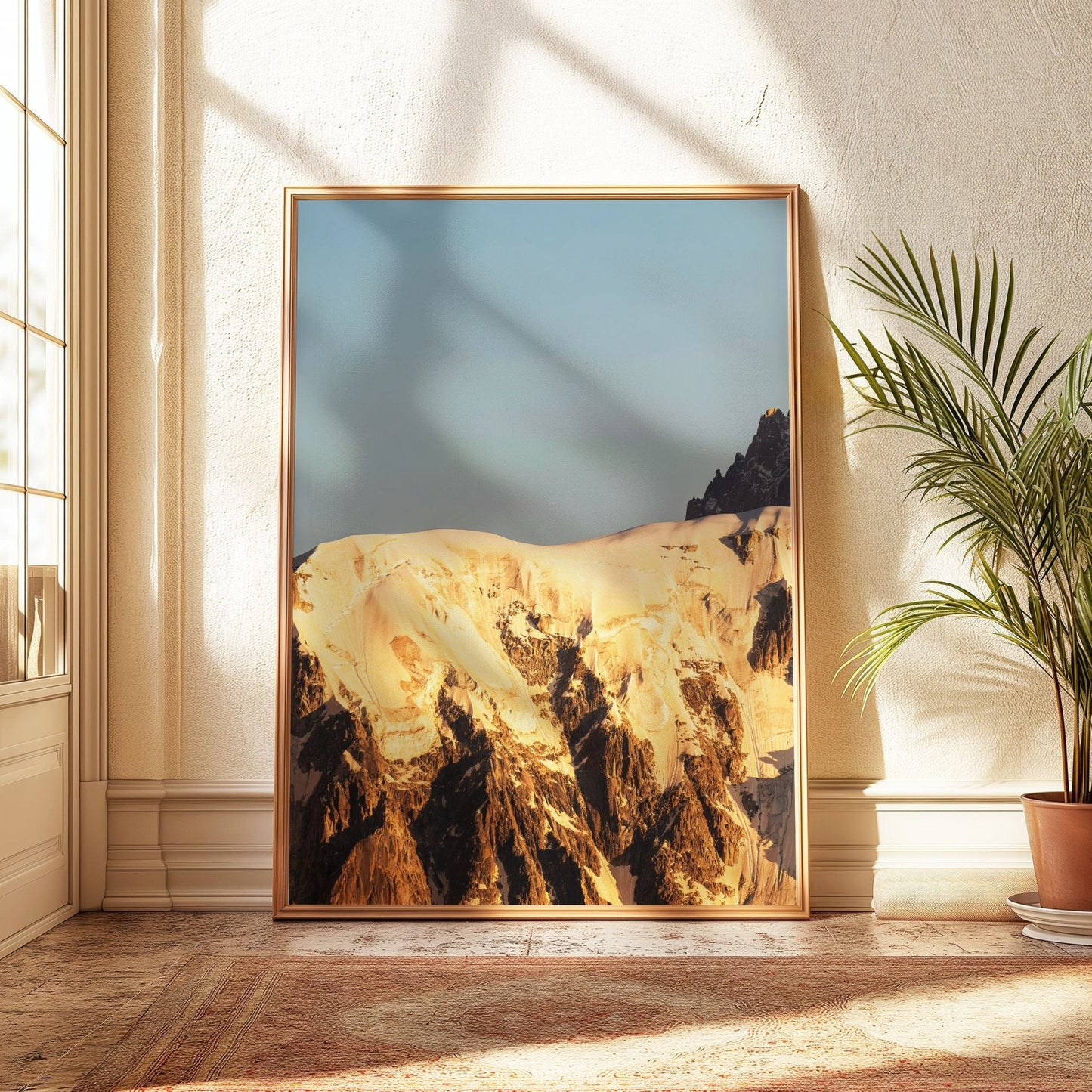 Expansive view of the Mont Blanc summit glowing with golden morning light, highlighting the natural beauty of the mountain landscape.